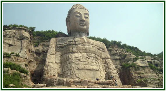 Estátua do Grande Buda de Mengshan esculpida na pedra de uma montanha rochosa na China, ilustrando a nota editorial do livro O Dhammapada.