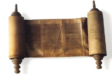 An ancient, partially unrolled Sefer Torah scroll made of weathered parchment, displaying columns of handwritten Hebrew text, mounted on two carved wooden rollers and isolated against a white background.