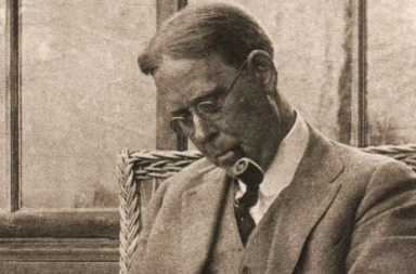 Retrato clásico en sepia de John Garrigues con gafas y pipa, escritor vinculado al estudio de la confianza en los maestros.