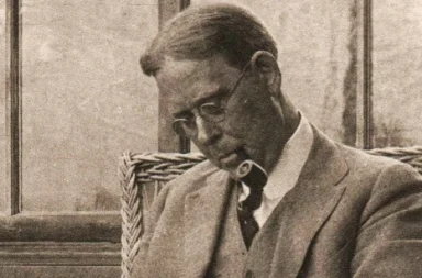 Retrato clásico en sepia de John Garrigues con gafas y pipa, escritor vinculado al estudio de la confianza en los maestros.